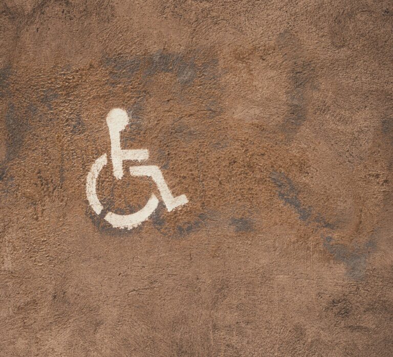 a white symbol of handicap on a brown surface